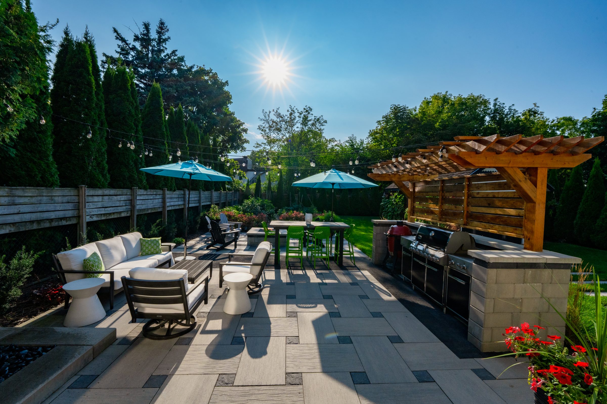 Sunny backyard patio with pergola and seating area