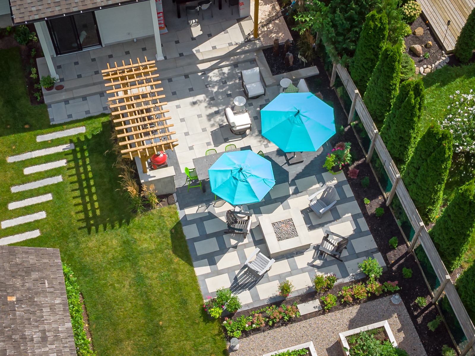 Aerial view of modern backyard patio with umbrellas