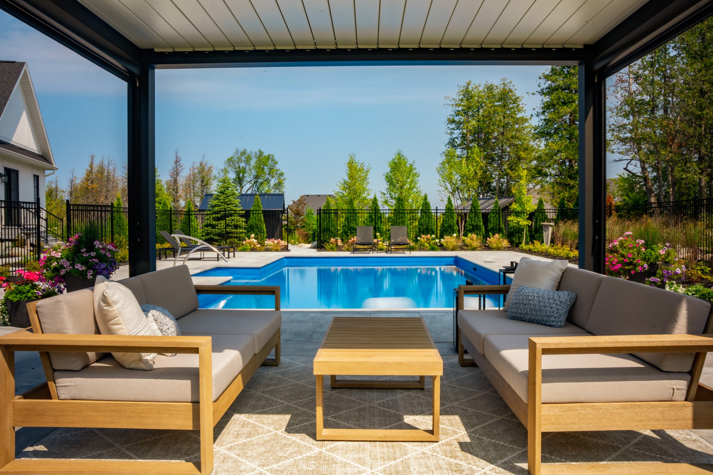 Covered patio seating overlooking backyard swimming pool