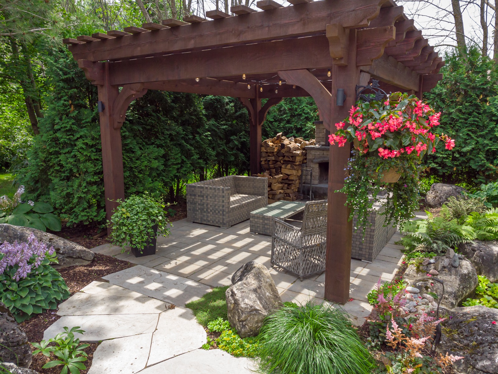Wooden pergola with patio seating and garden landscaping