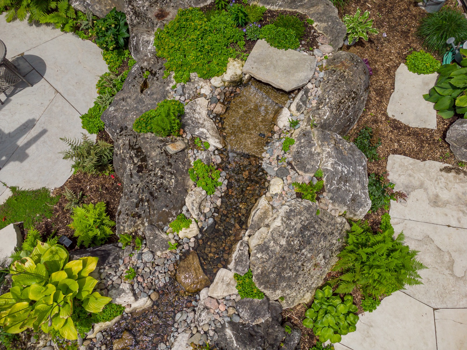 Aerial view of backyard garden waterfall and stream