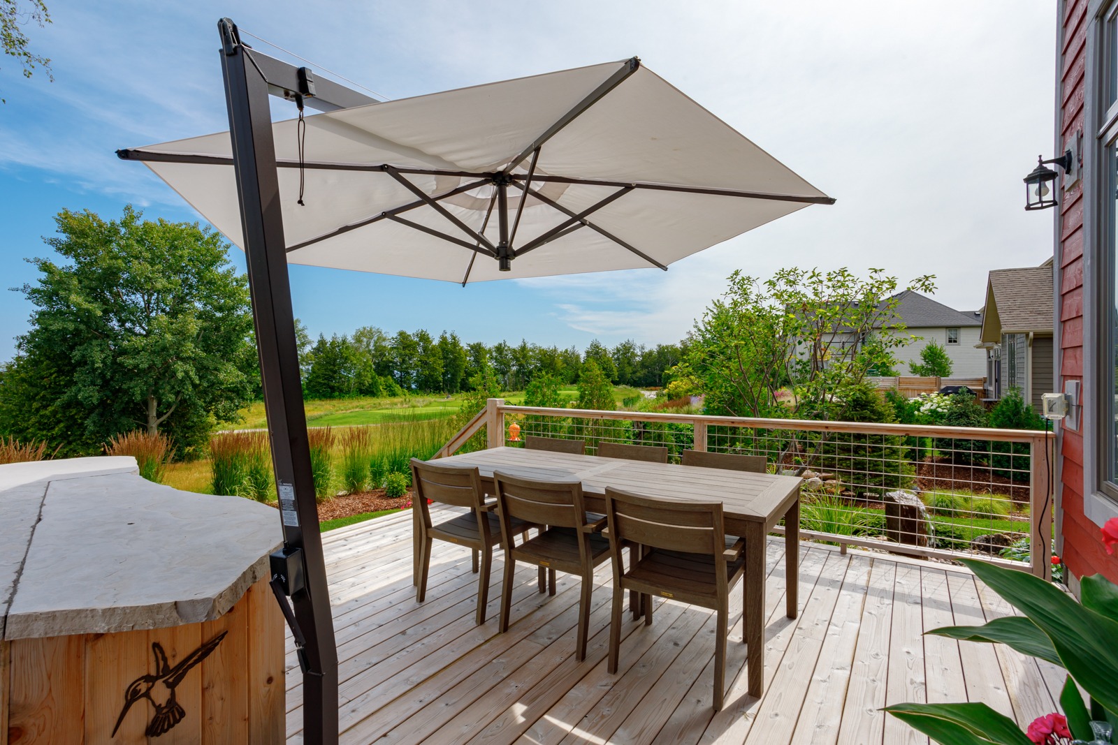 Backyard deck with table, chairs, and umbrella