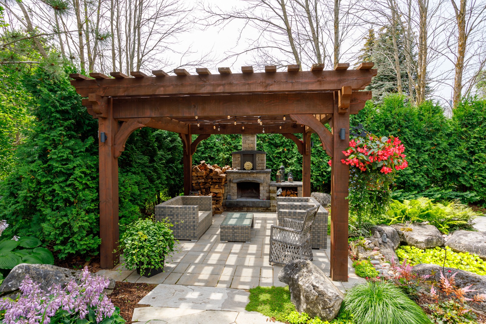 Backyard pergola with fireplace and garden seating