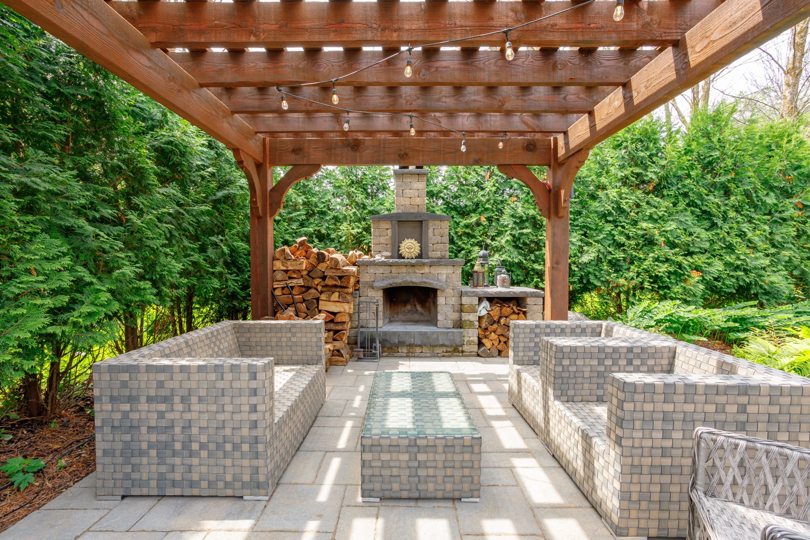 Backyard patio with pergola and stone fireplace