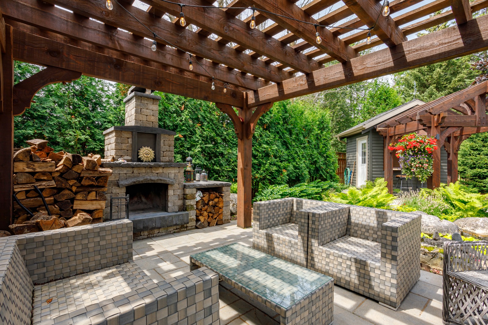 Backyard patio with pergola and stone fireplace
