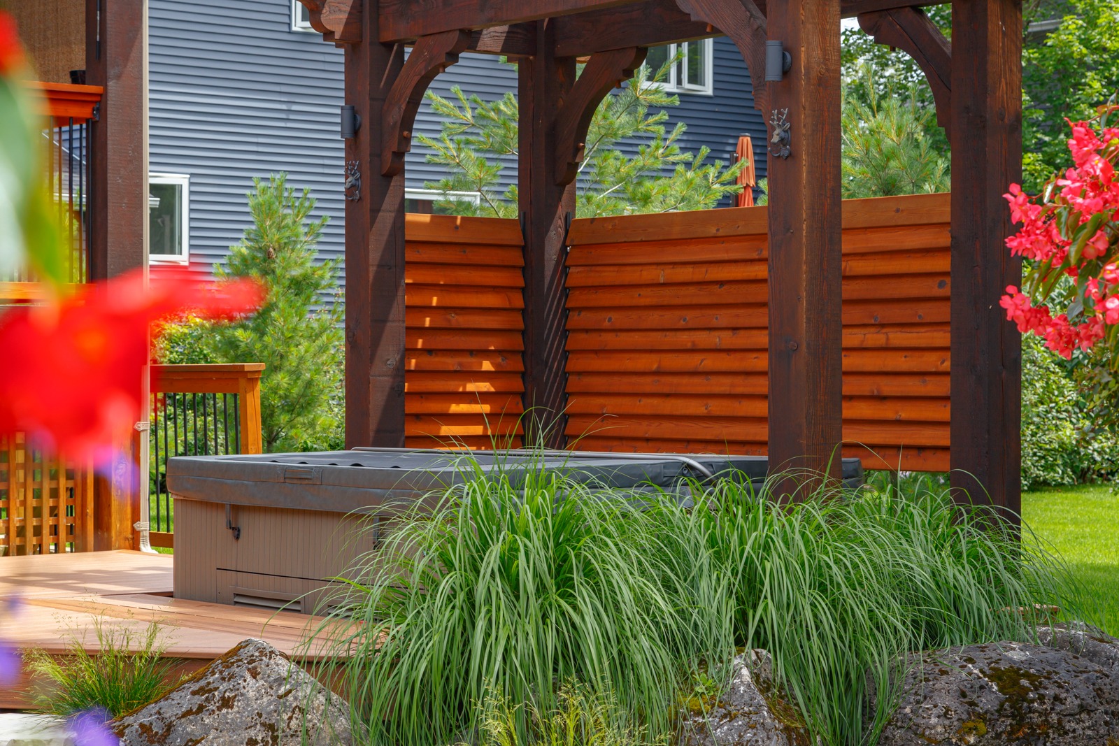 Backyard pergola with hot tub and privacy screen