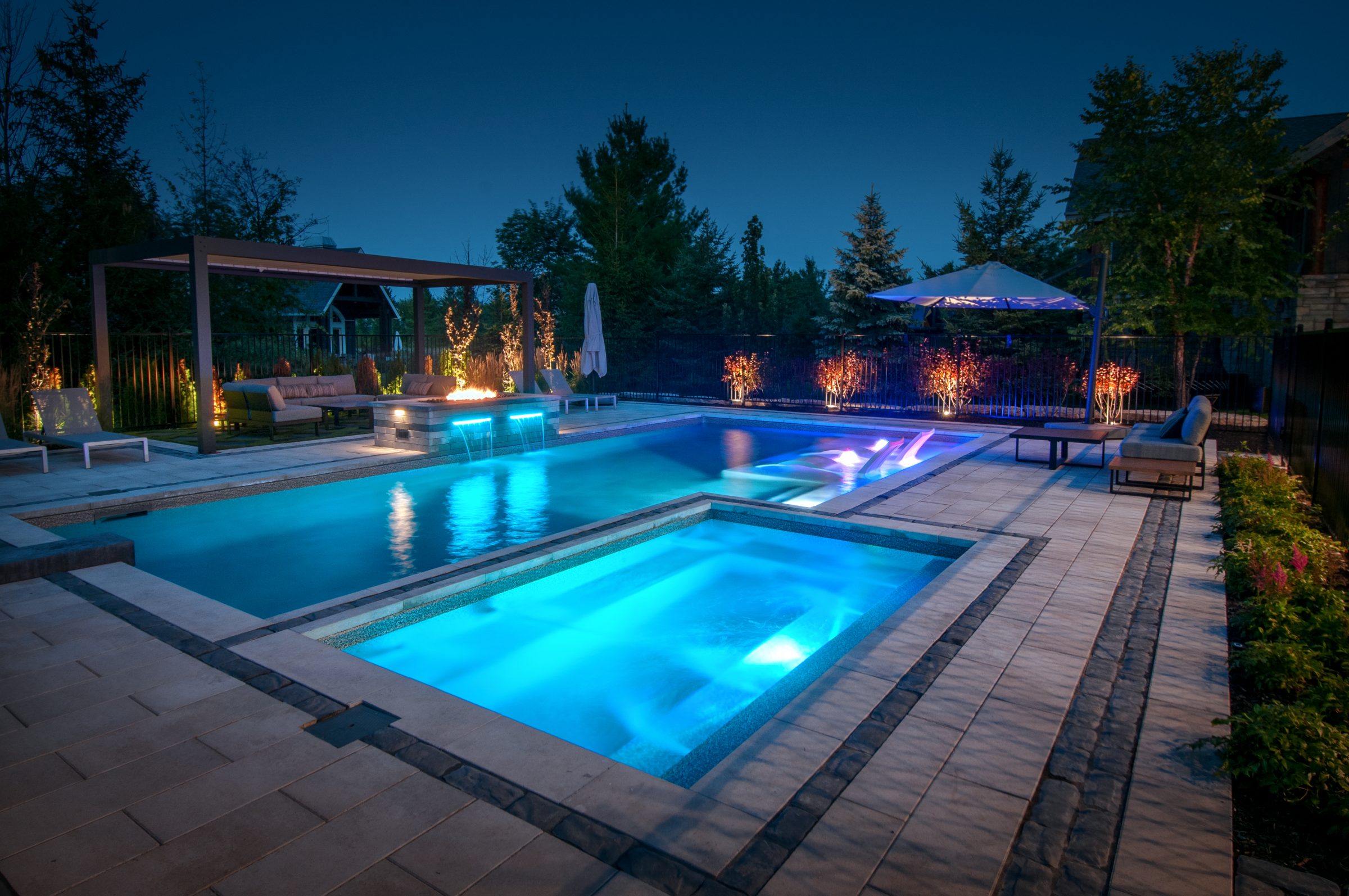 Luxury backyard pool and spa at dusk