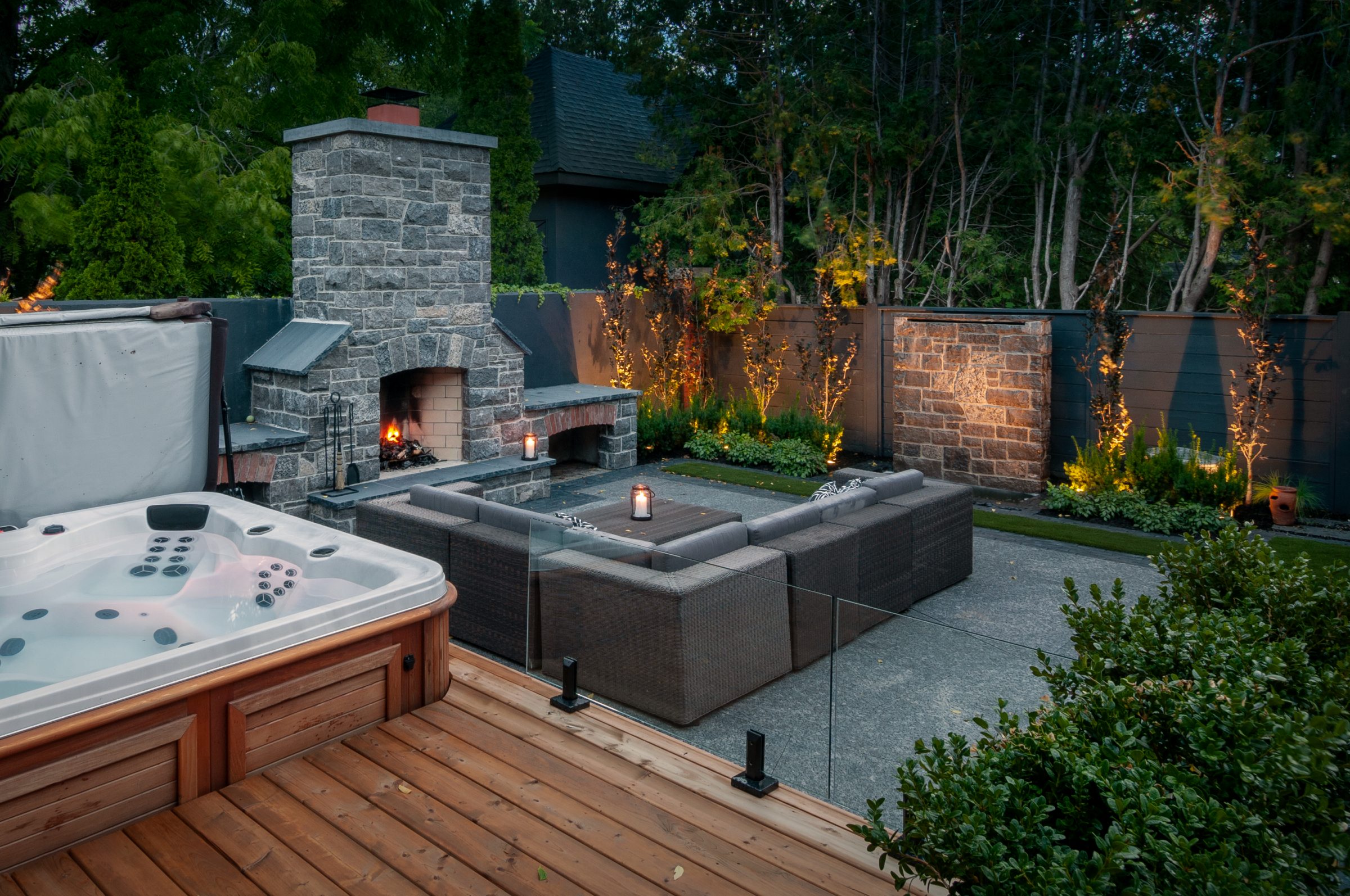 Modern backyard patio with hot tub and fireplace