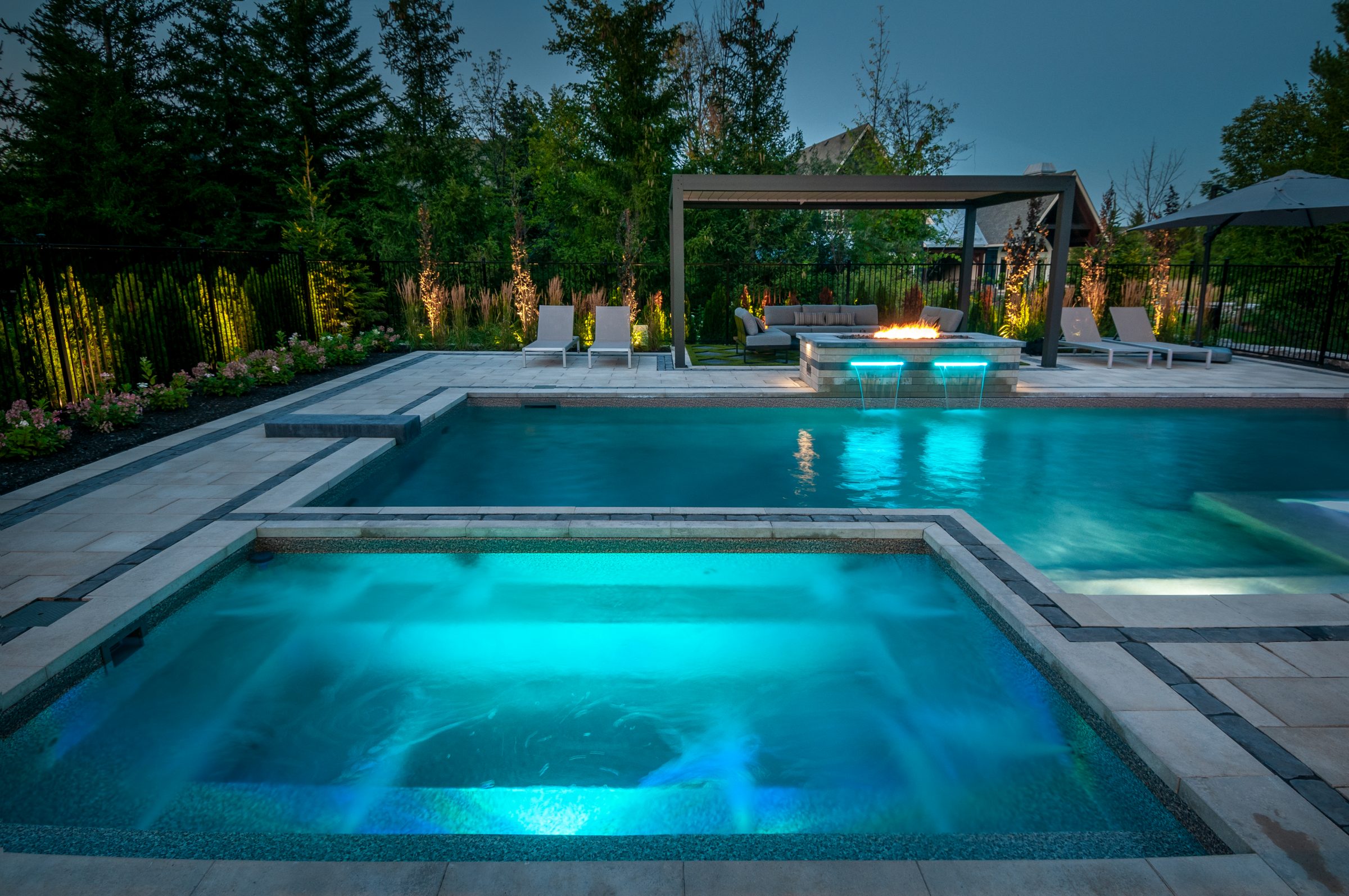 Luxury backyard pool and spa at dusk