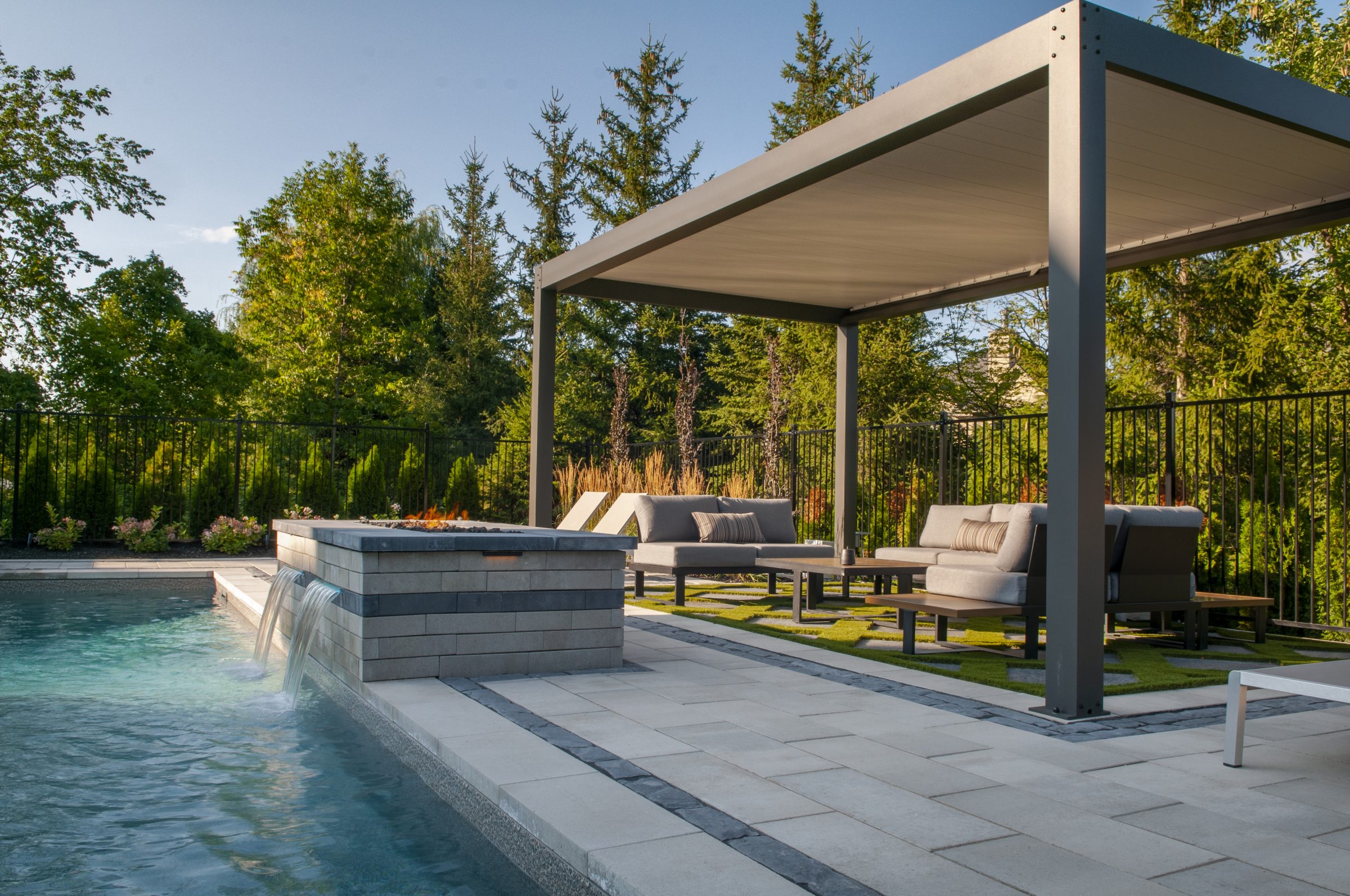 Modern backyard pool with pergola seating area