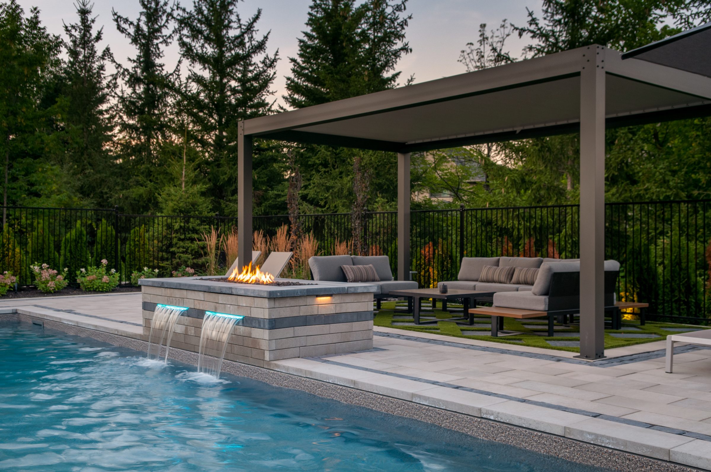Modern backyard pool with fire feature and pergola