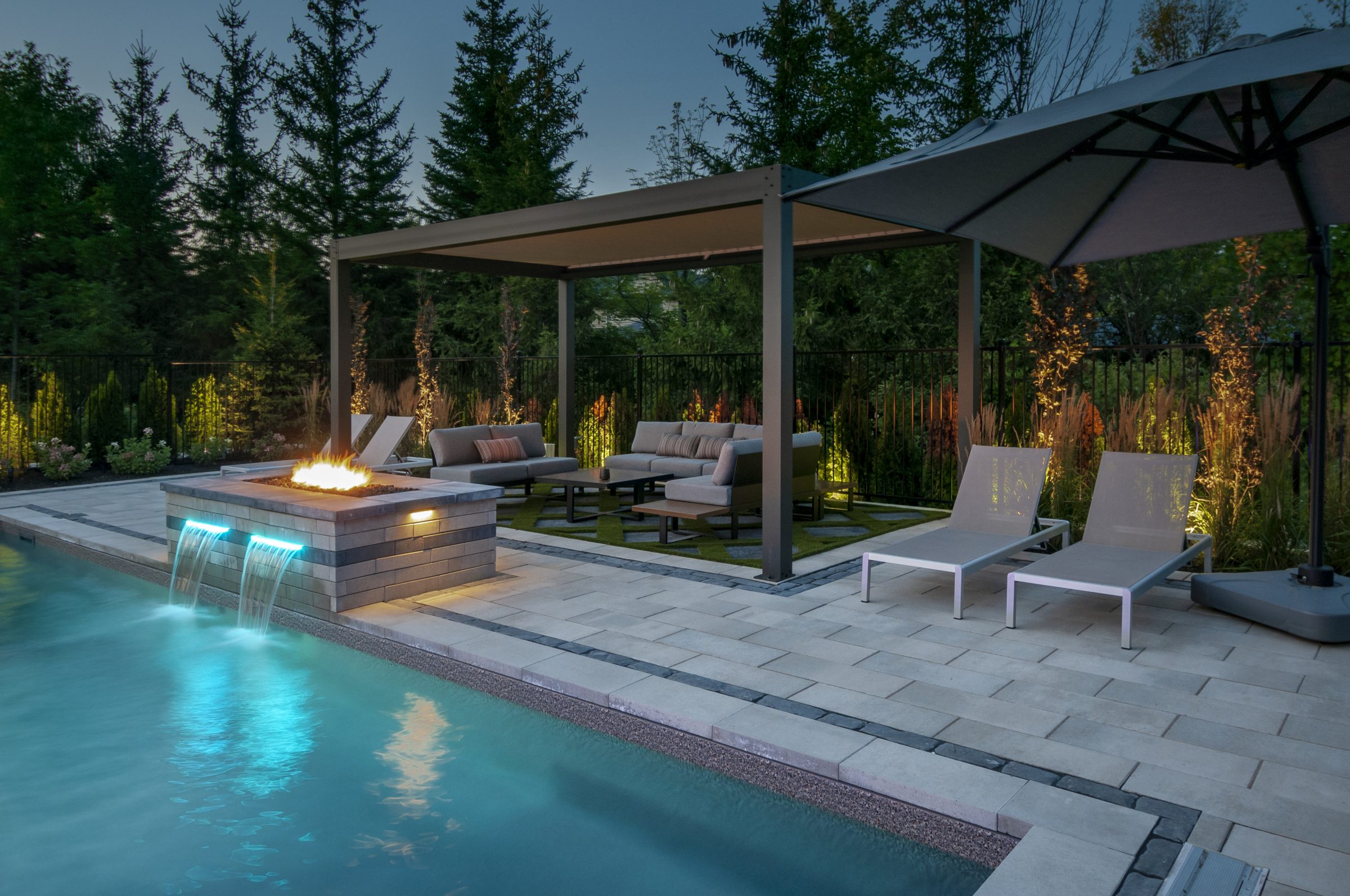 Modern backyard pool with fire feature and pergola