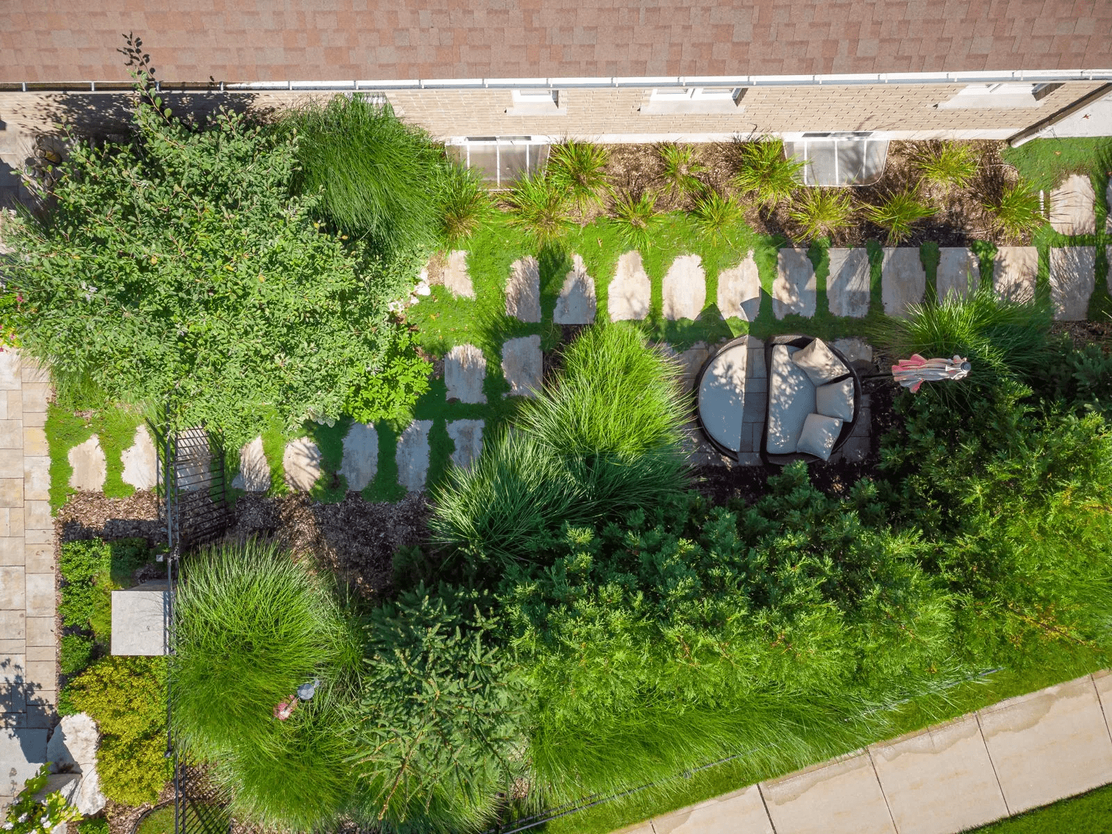 Aerial view of landscaped backyard with stone pathway