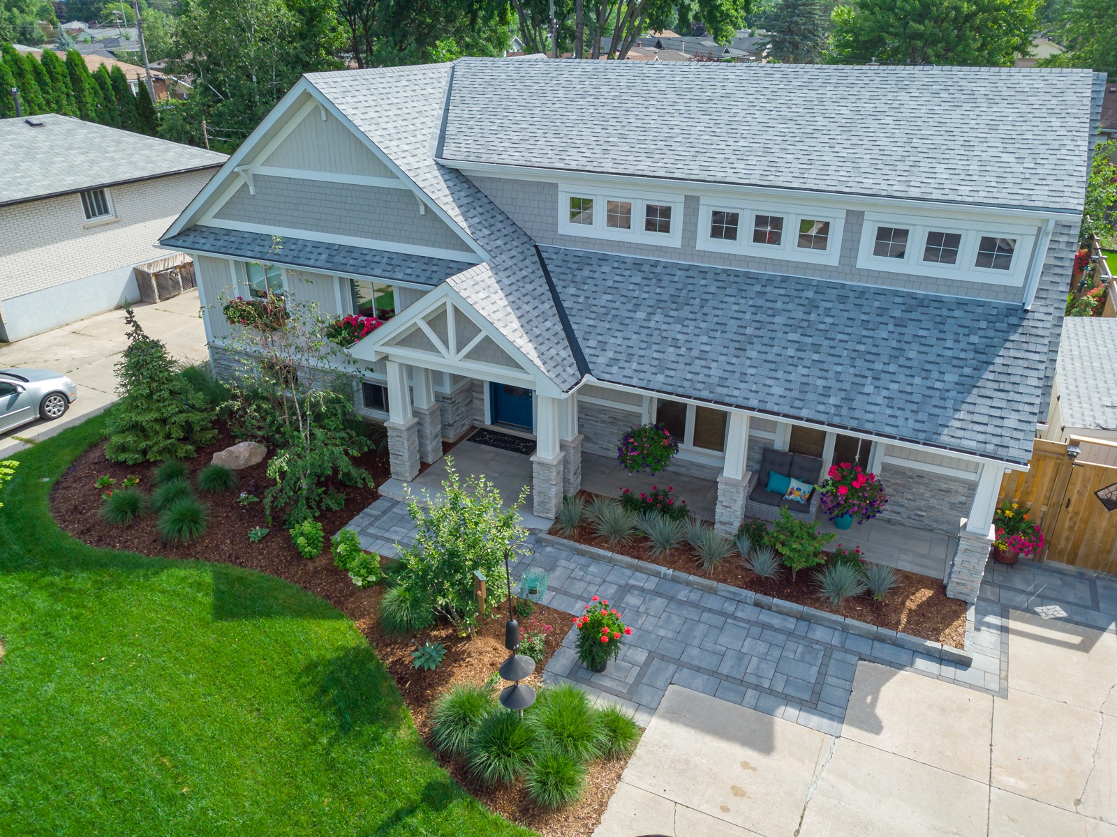Aerial view of landscaped craftsman-style suburban home