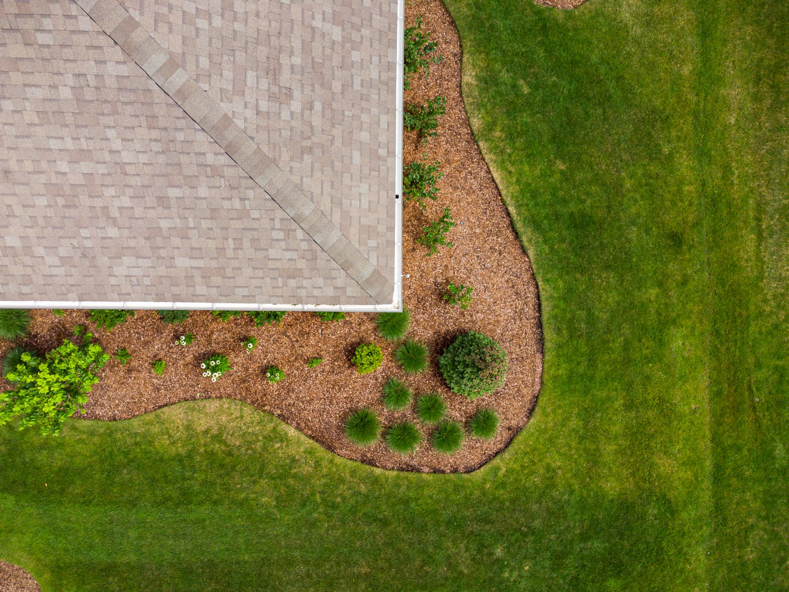 Aerial view of landscaped yard and roof corner