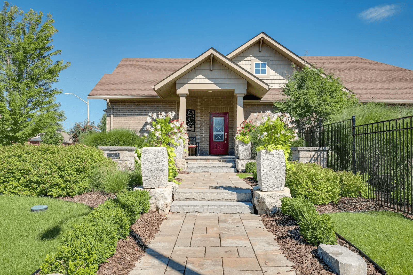 Suburban home with stone walkway and red door