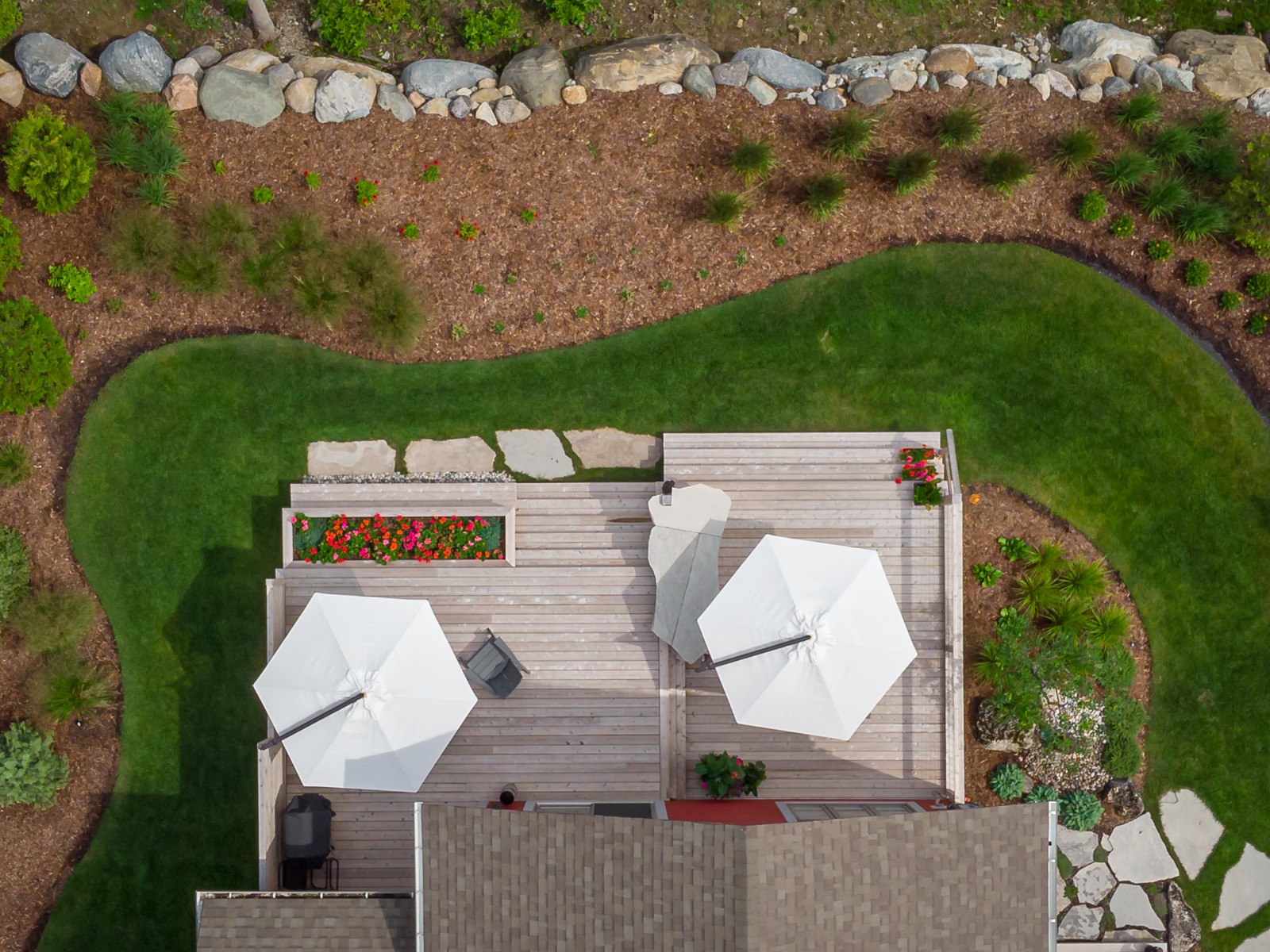 Aerial view of backyard deck with umbrellas