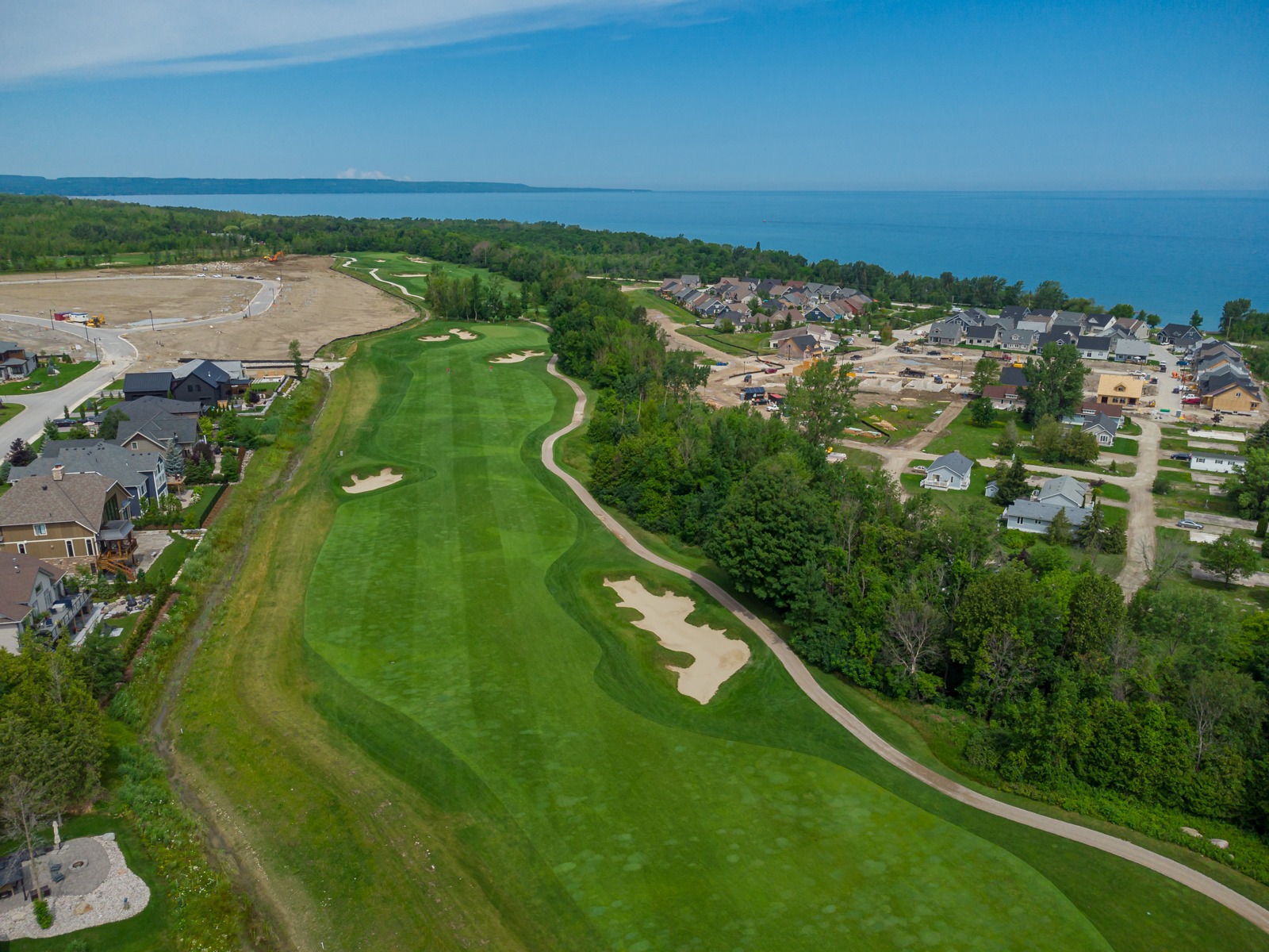 Aerial view of lakeside golf course and homes
