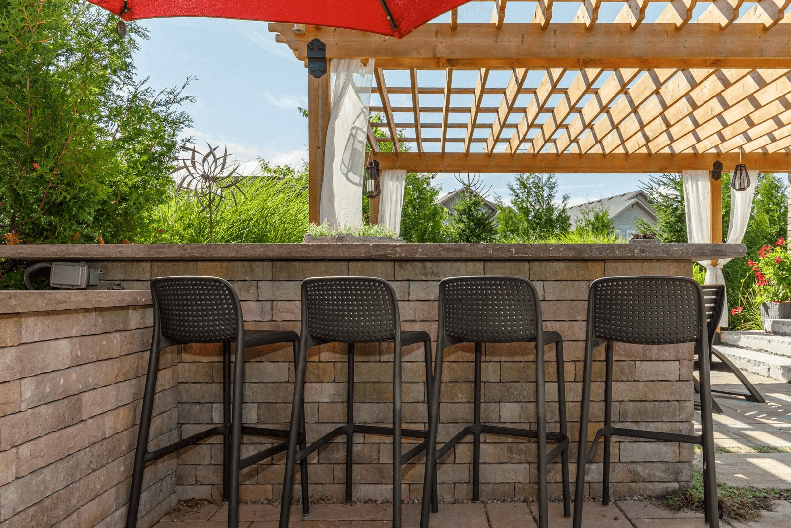 Outdoor patio bar with stools and pergola