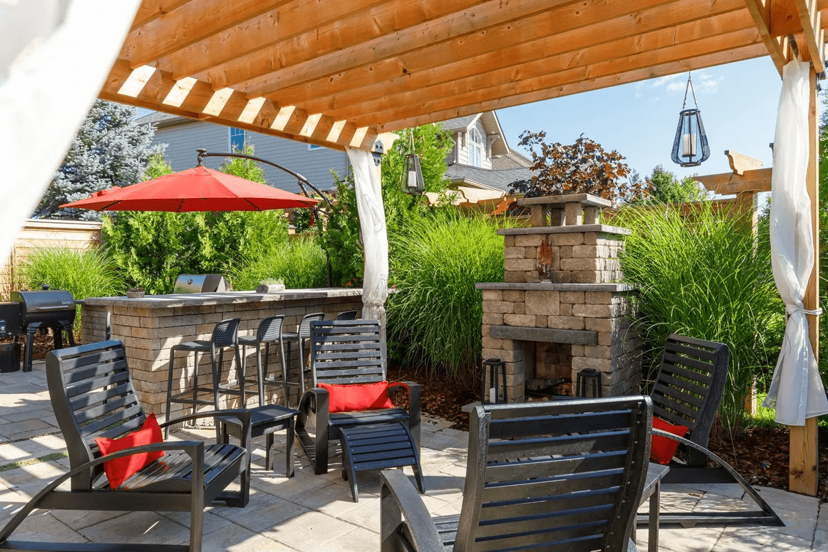 Backyard patio with pergola, fireplace, and bar seating