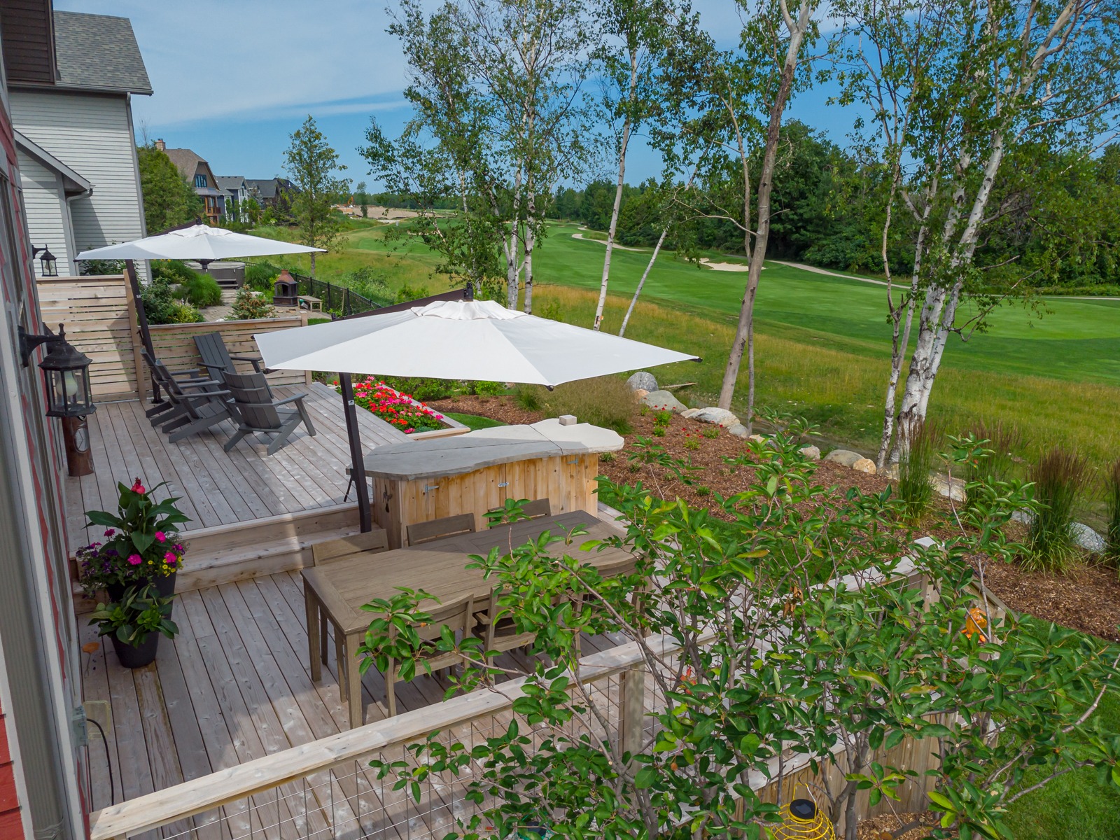 Wooden backyard deck overlooking lush golf course