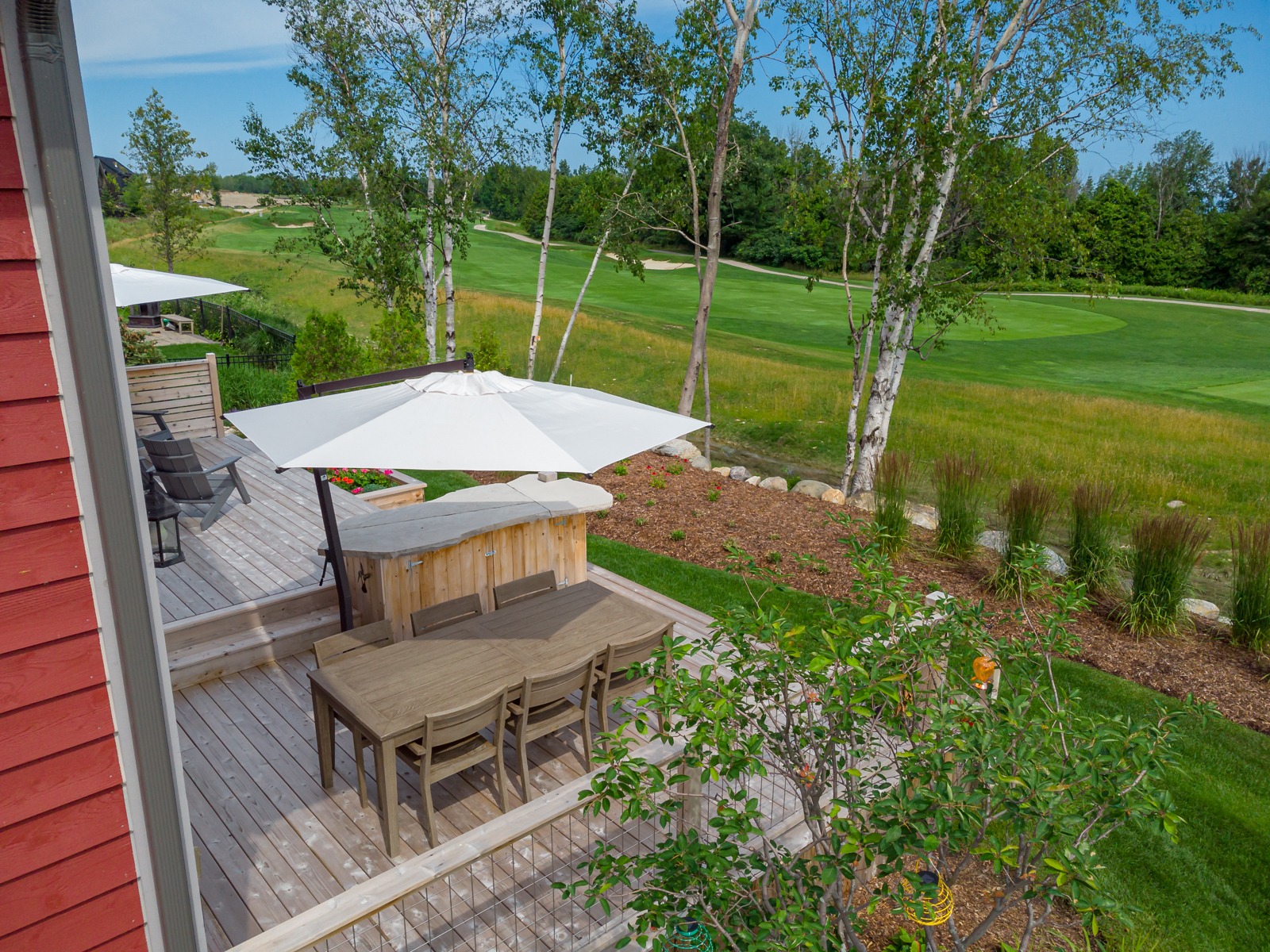 Backyard deck overlooking lush green golf course