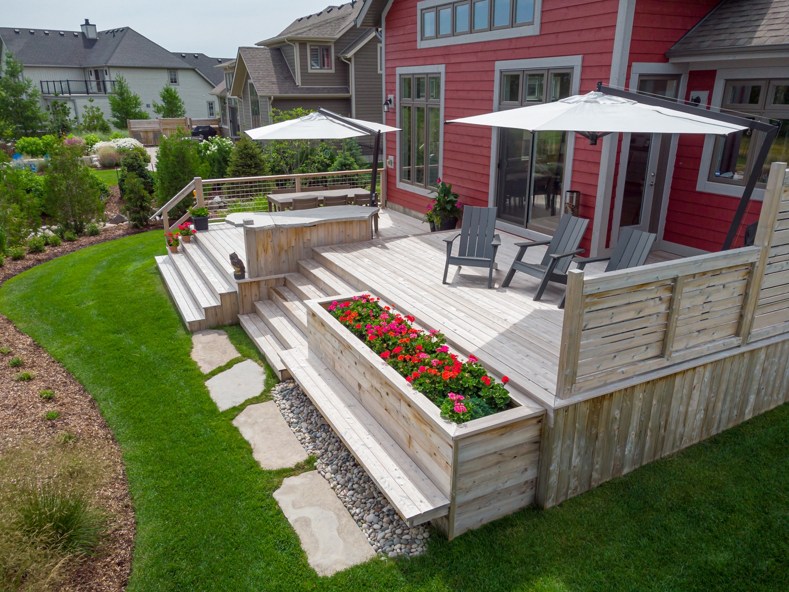 Modern wooden backyard deck with seating and planters