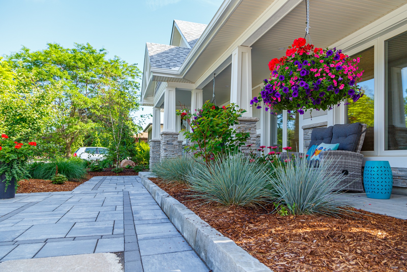 Landscaped front porch with hanging flower baskets