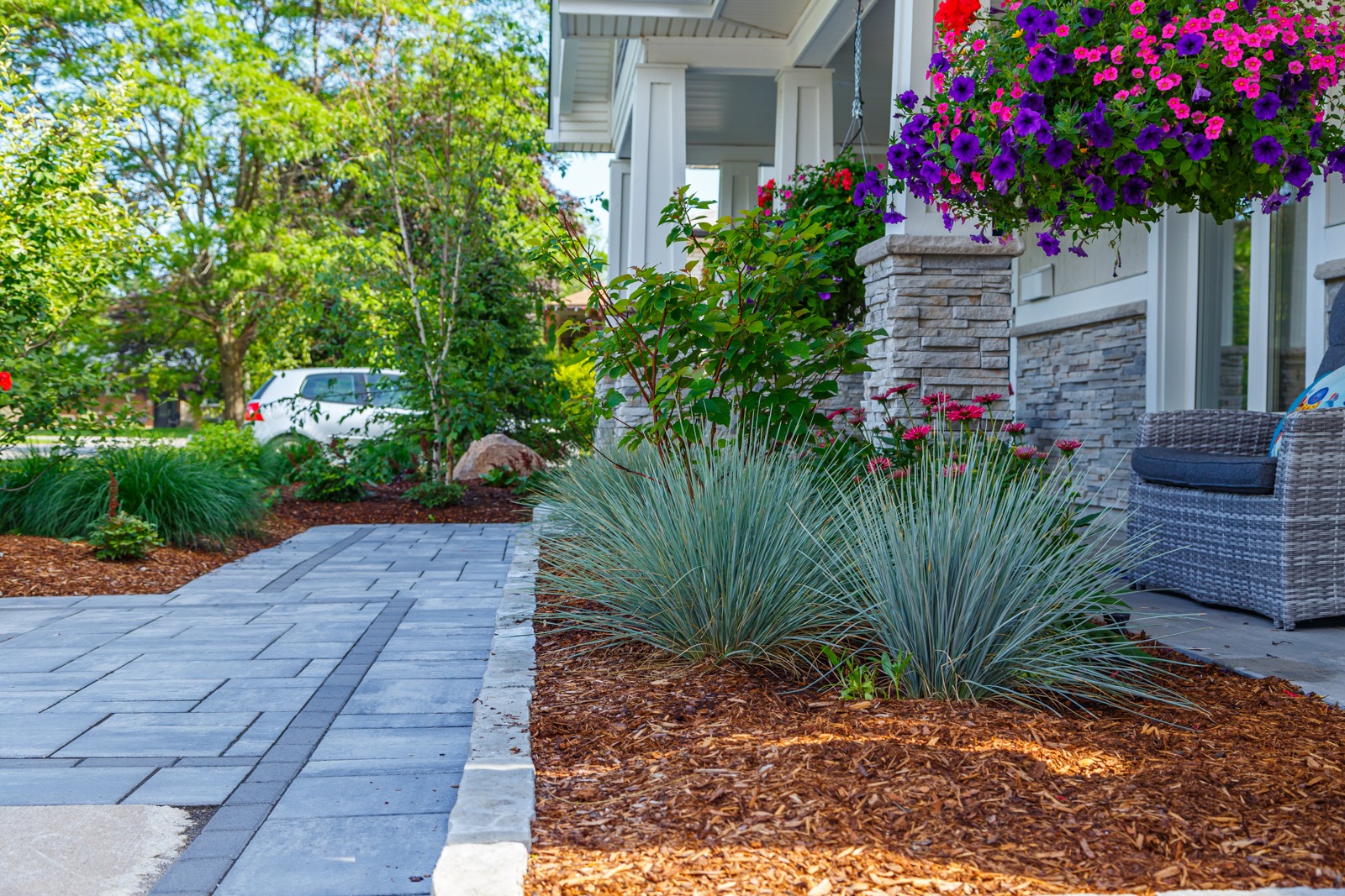 Landscaped front yard with stone walkway and flowers