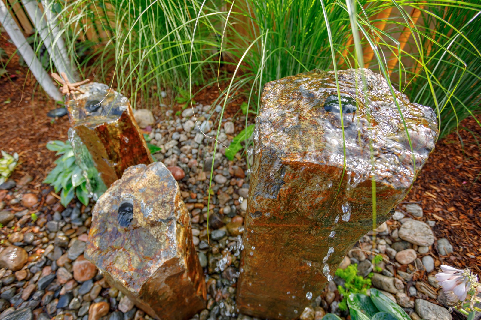 Small stone garden fountain with flowing water