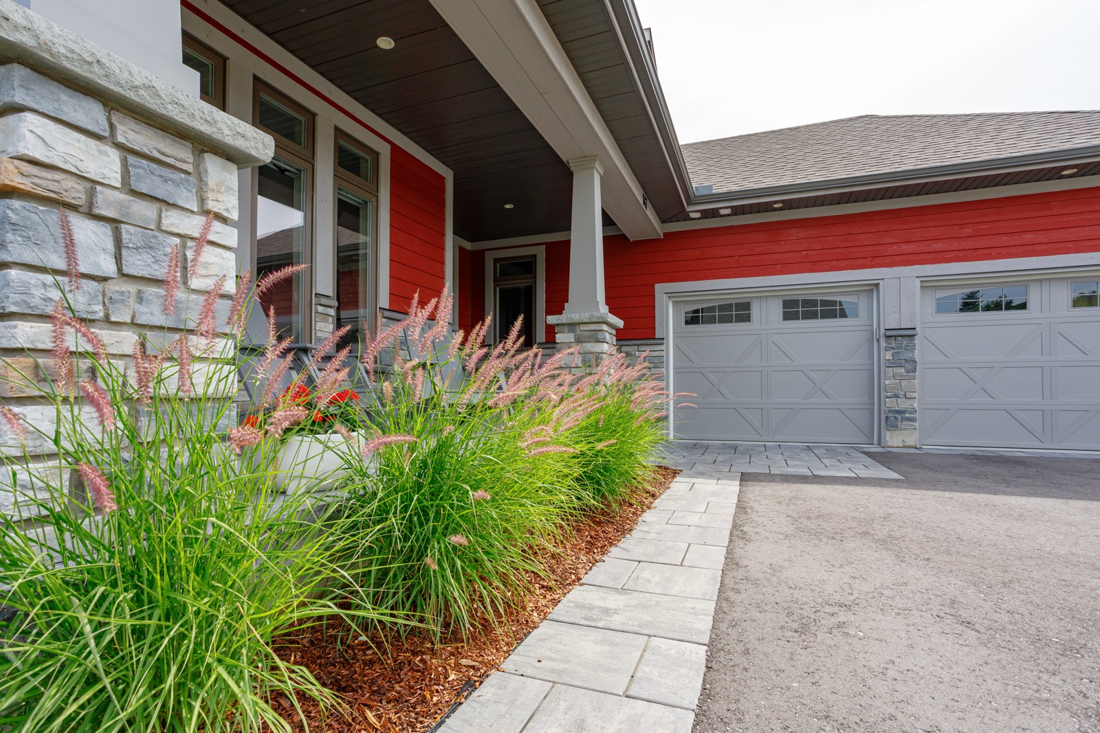Modern red house with stone accents and garage