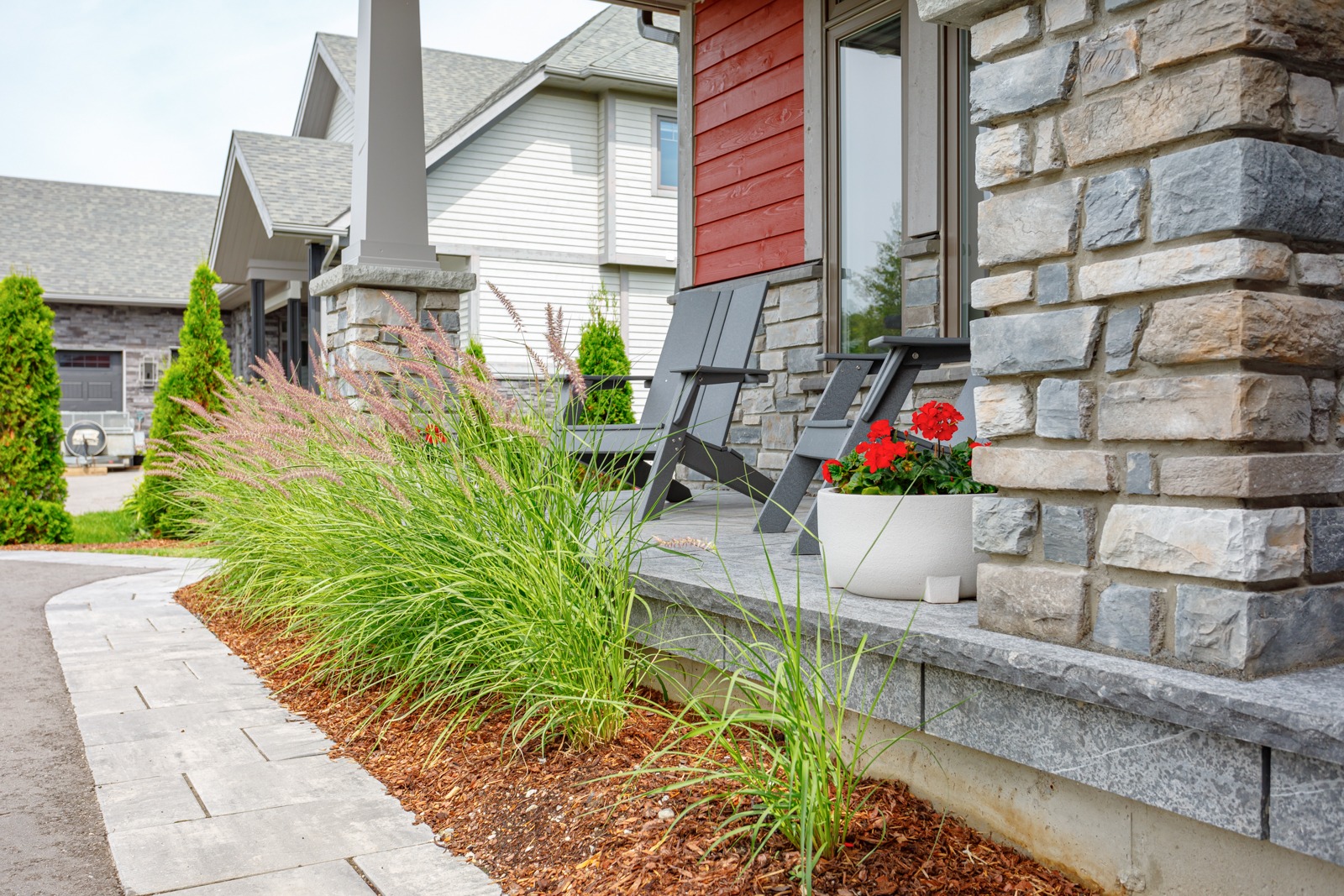 Front porch with stone pillars and garden plants