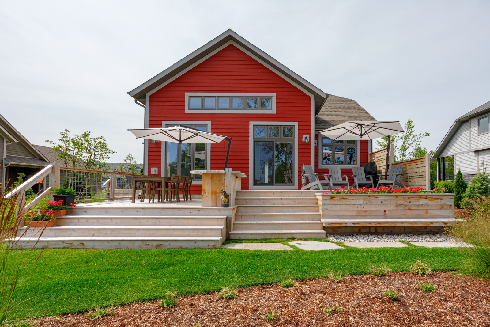Red modern house with spacious wooden deck