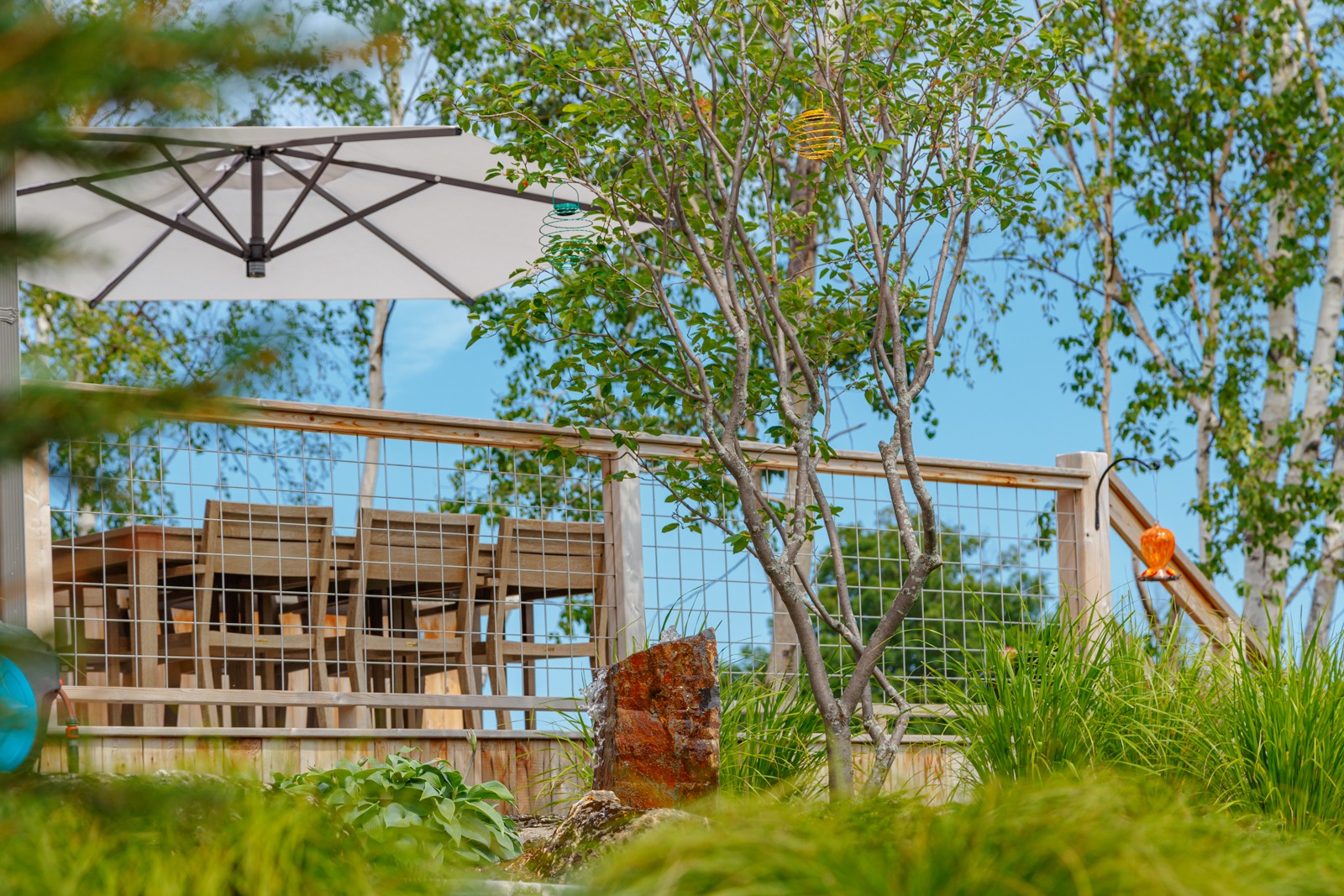 Backyard patio with wooden deck and garden