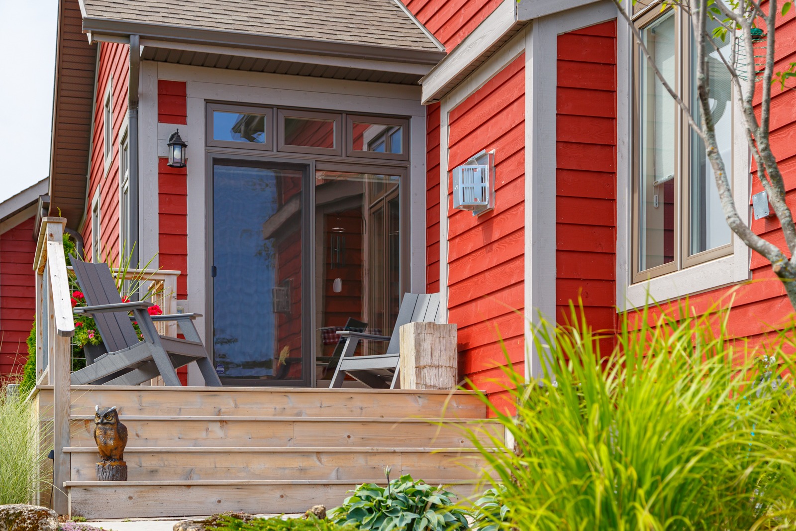 Red house porch with chairs and sliding door