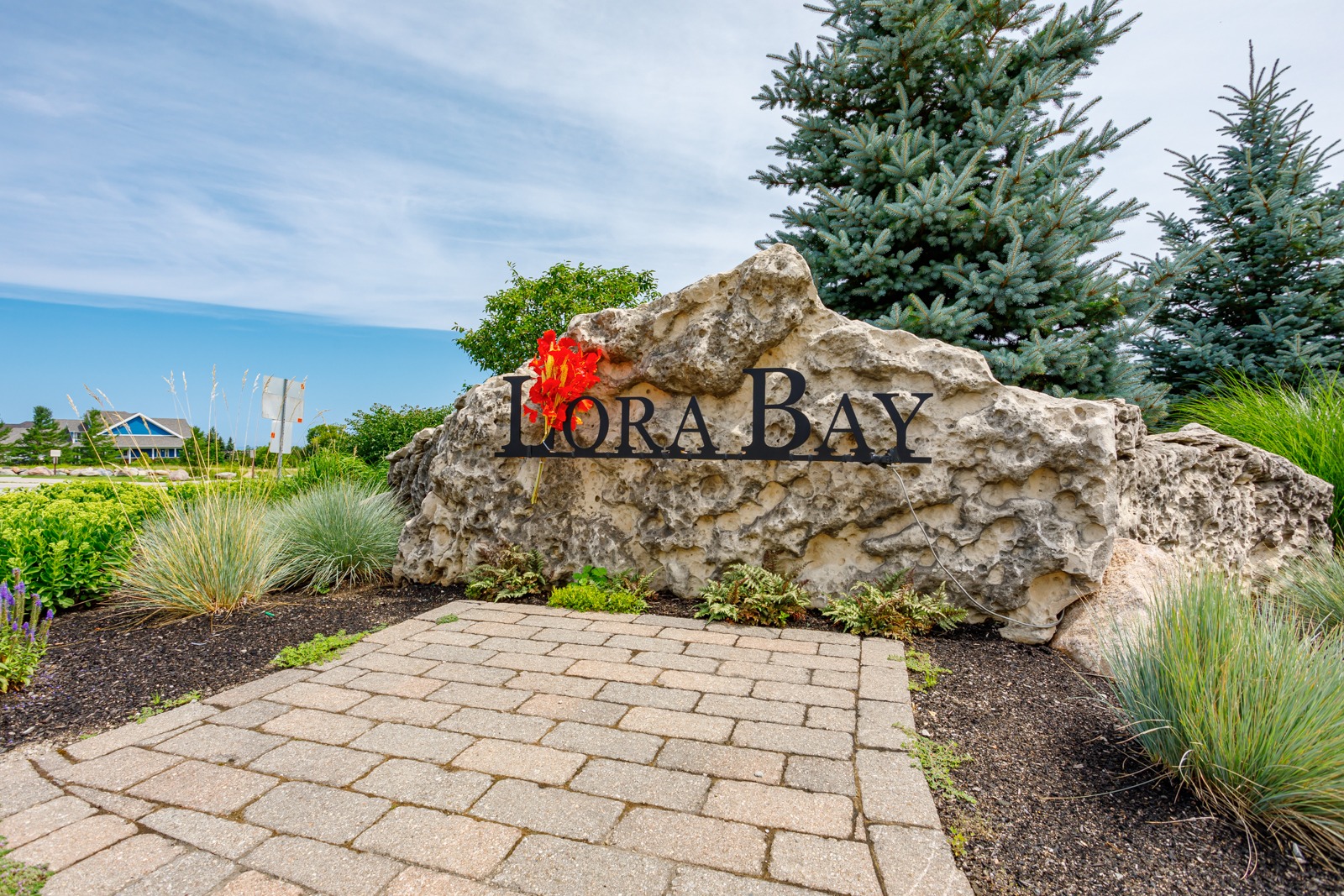 Lora Bay stone entrance sign with landscaping