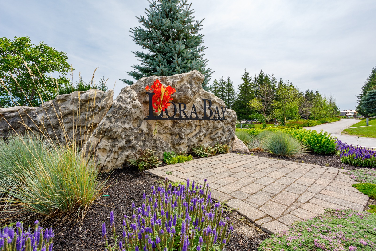 Stone Lora Bay entrance sign with landscaping