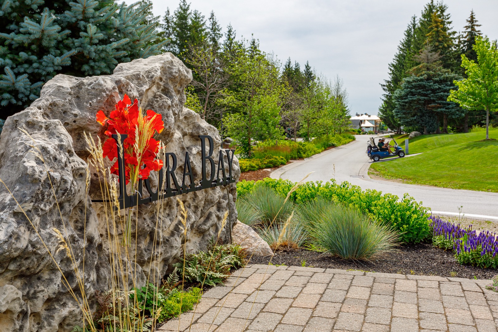 Lora Bay stone sign with golf course path