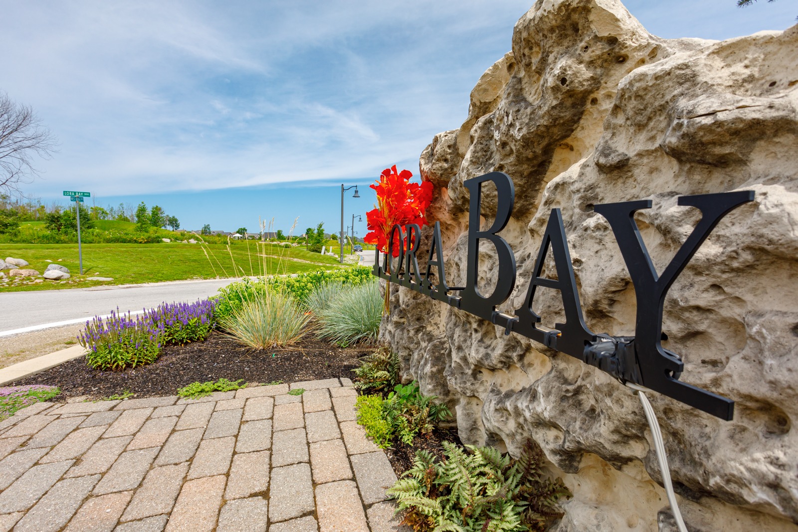 Lora Bay stone entrance sign with landscaping
