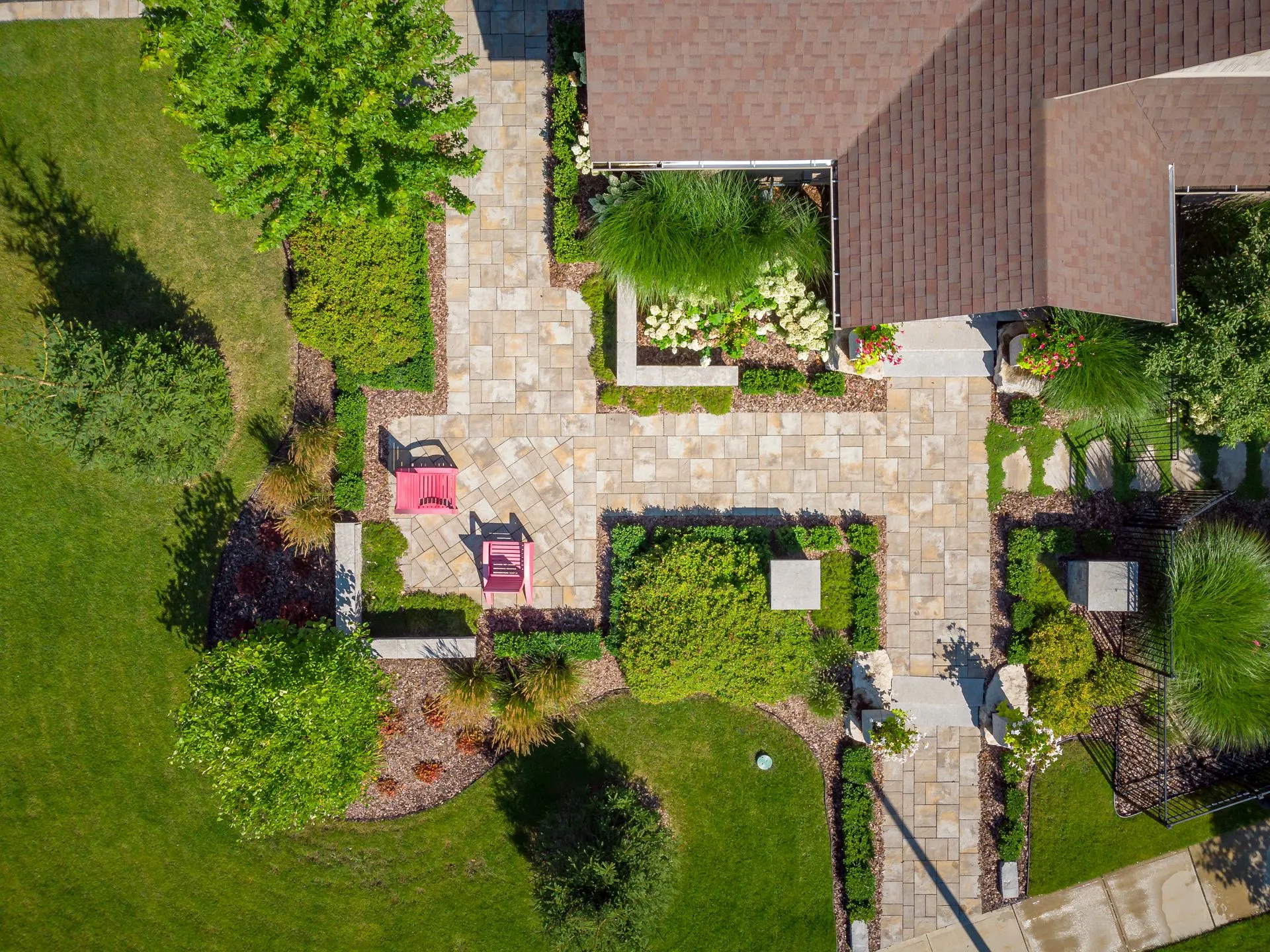 Aerial view of landscaped backyard with patio and chairs