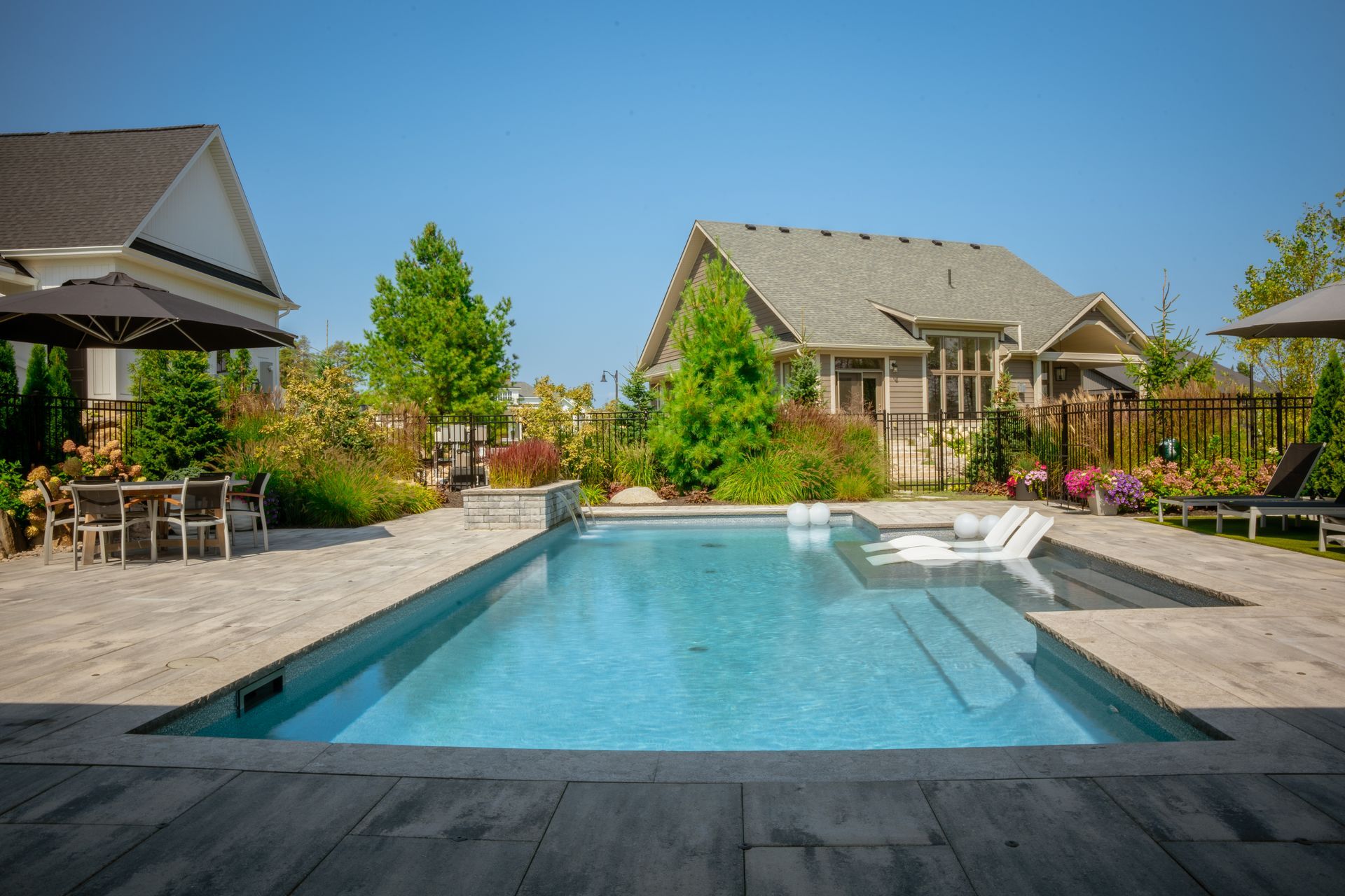 Modern backyard pool with patio and landscaping