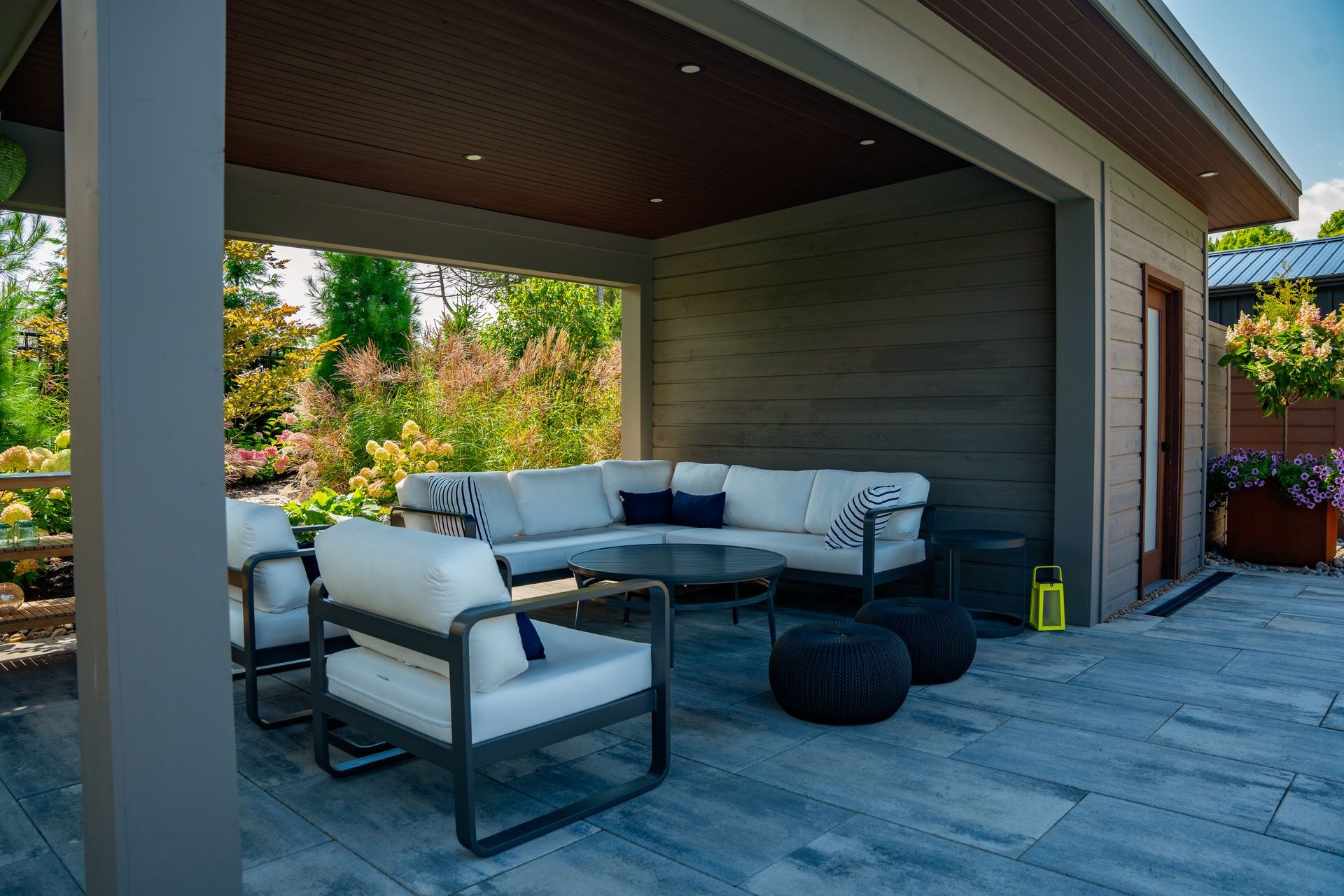 Modern covered patio with white outdoor sectional seating