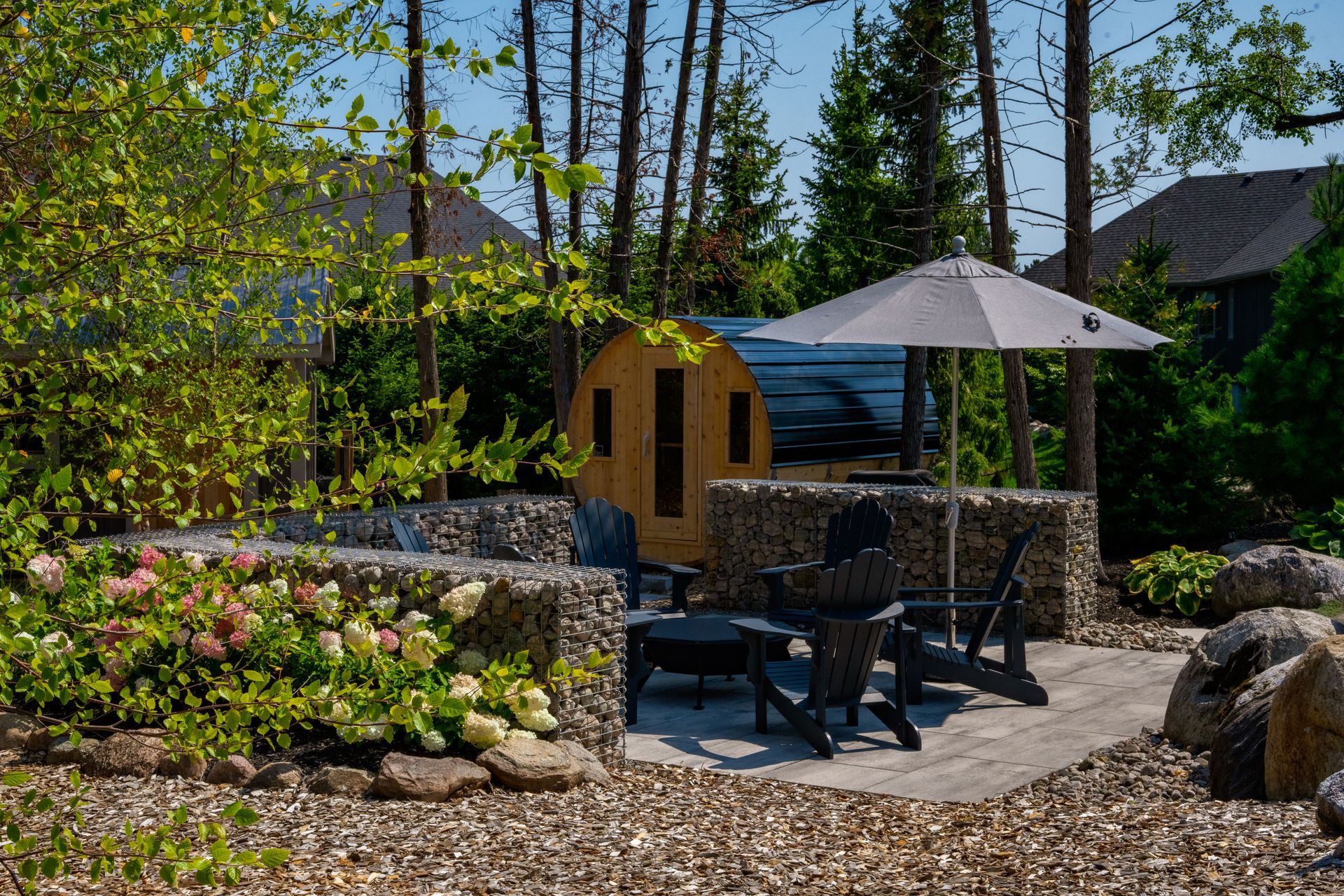 Backyard patio with sauna and Adirondack chairs