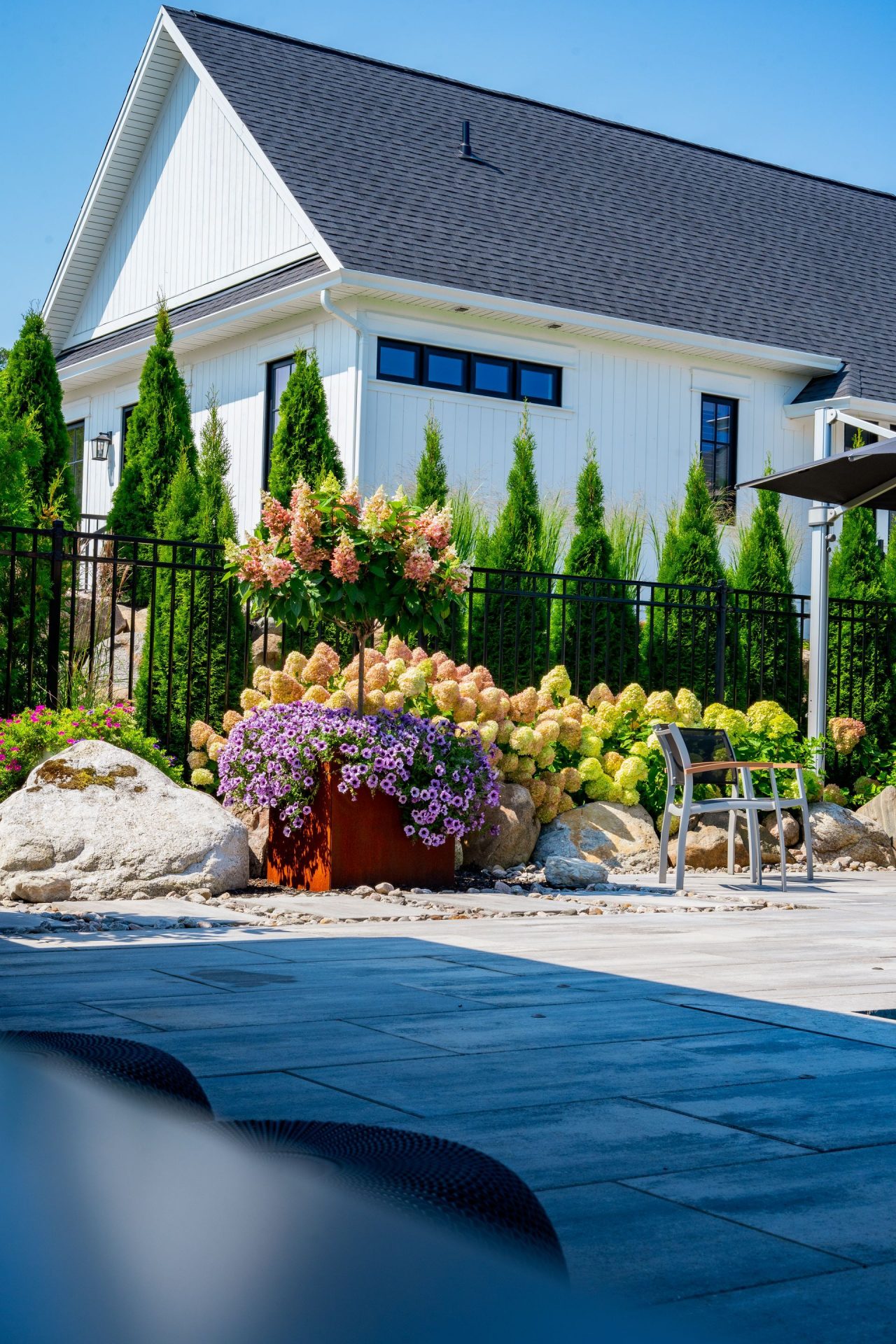 Modern white house with landscaped garden and patio