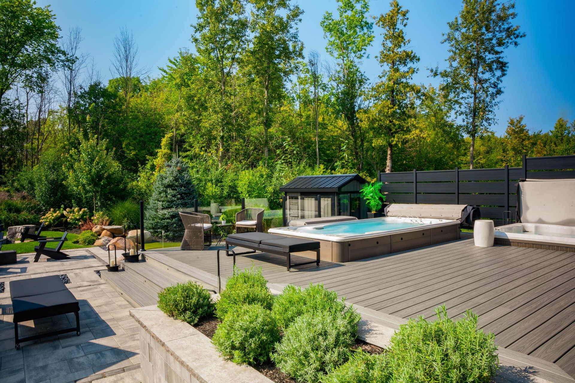 Modern backyard deck with hot tub and seating