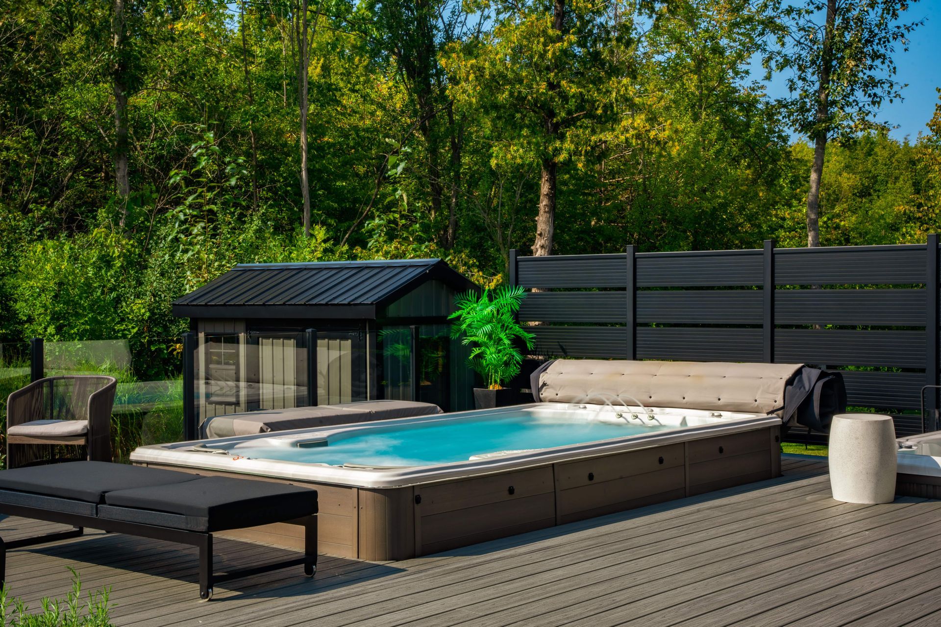 Modern backyard swim spa on wooden deck