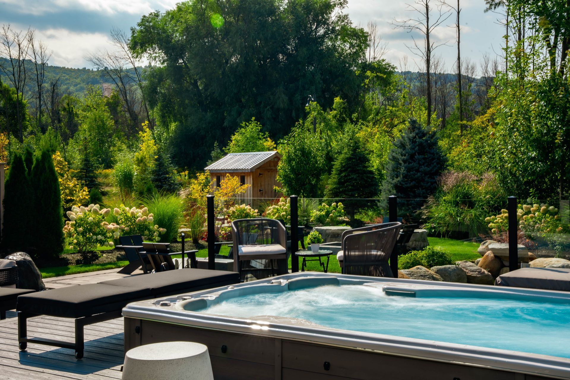 Backyard hot tub with landscaped garden and shed