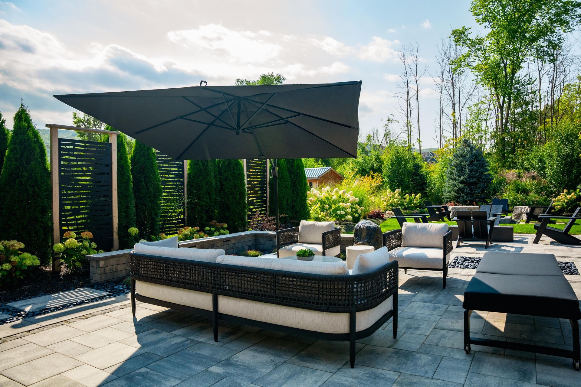Modern backyard patio with umbrella and lounge seating
