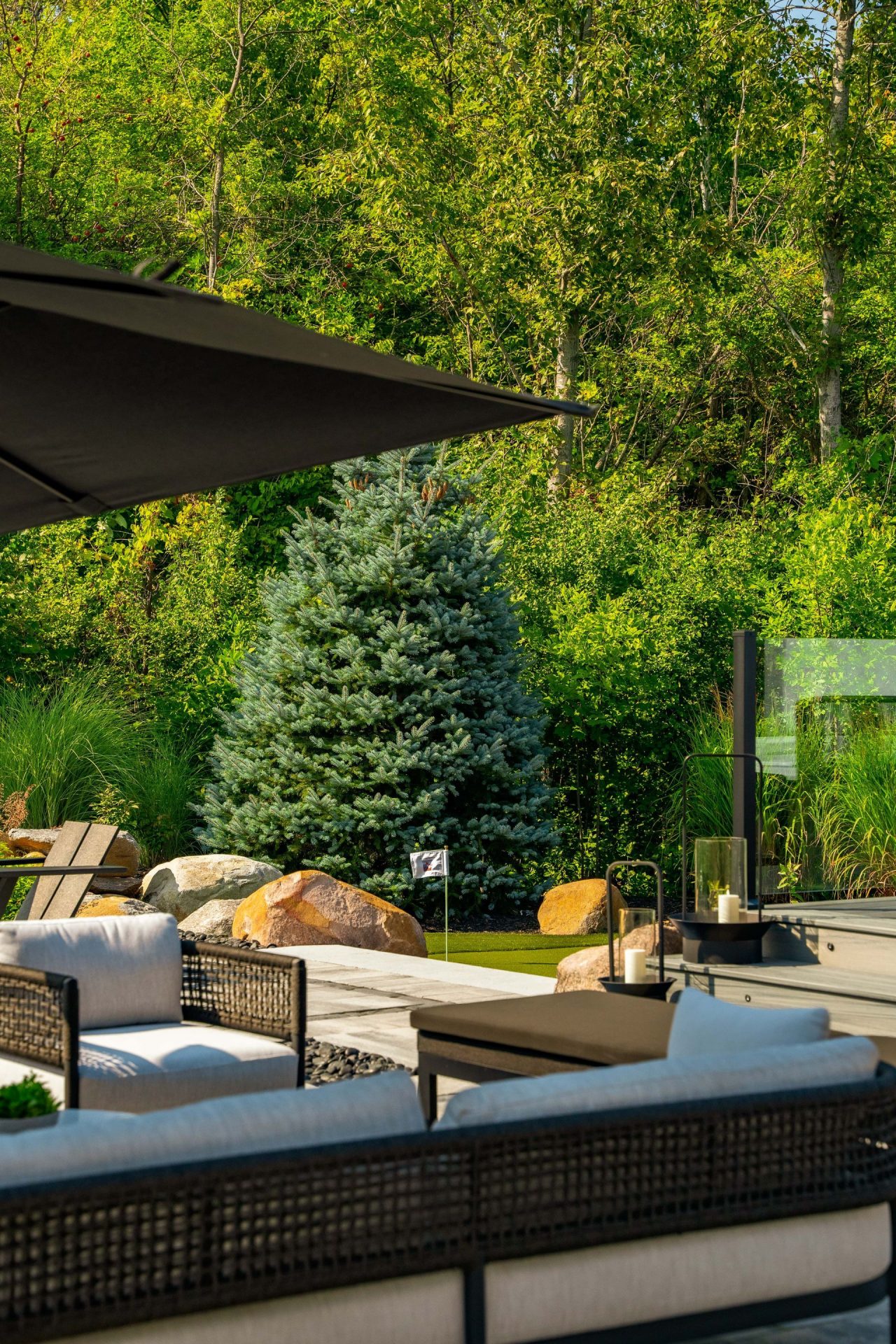 Modern patio seating overlooking lush landscaped garden
