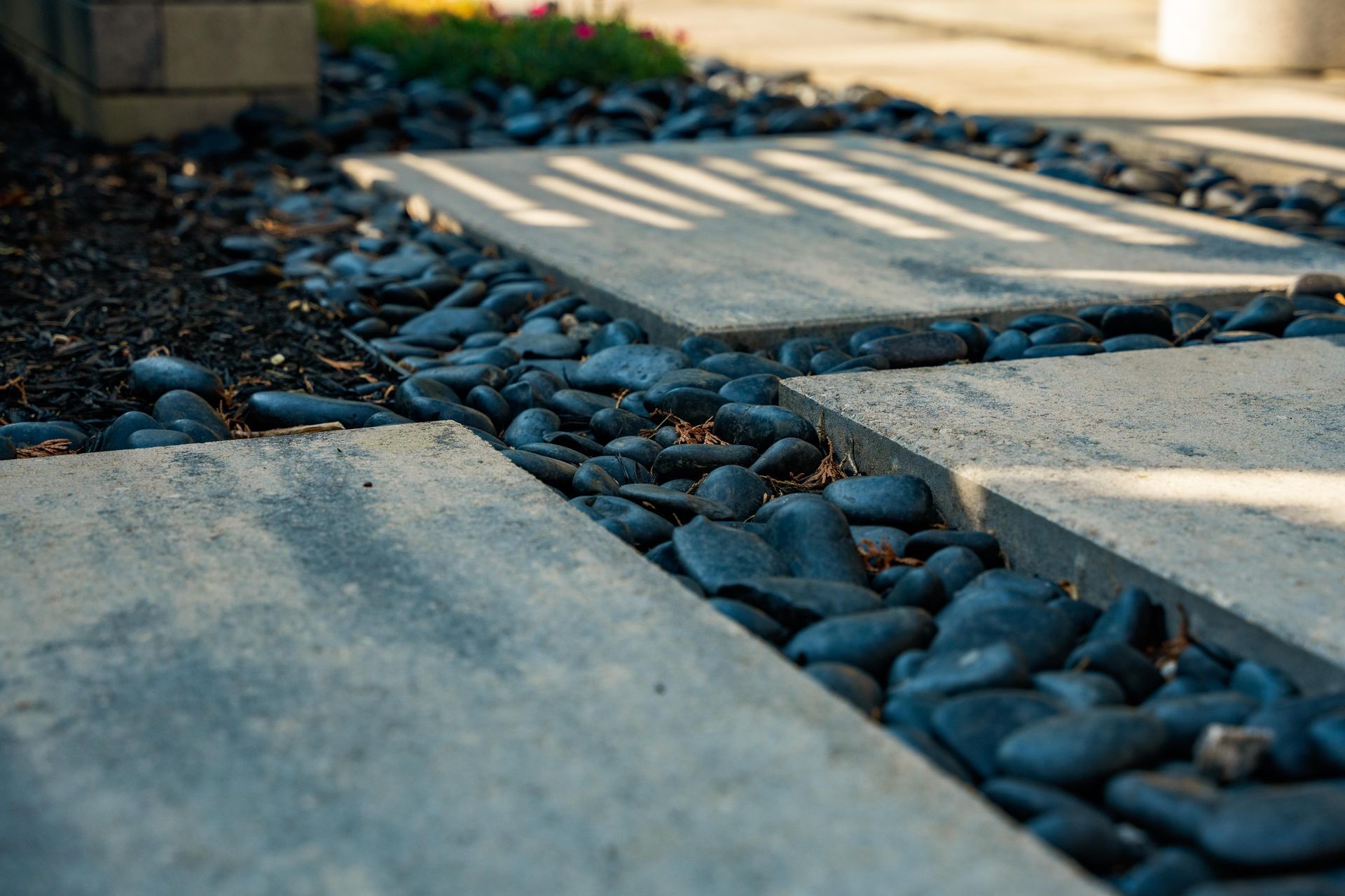 Modern stone pathway with black pebbles